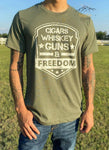 Heather Military Green T-Shirt with White Distressed Cigar, Whiskey, Guns, & Freedom Design.